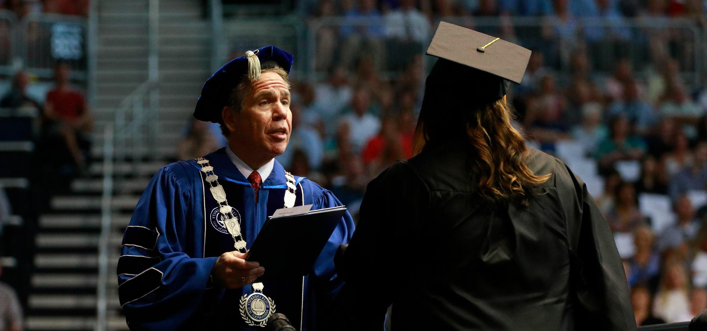 President Danko handing over diploma at commencement